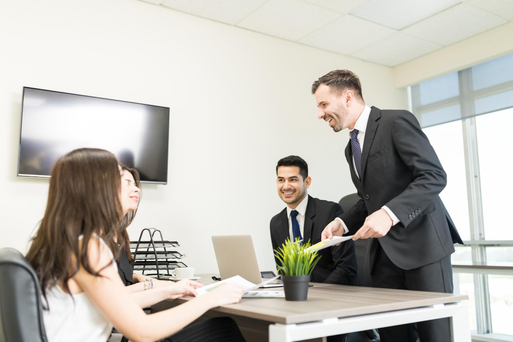 male-accountant-showing-financial-document-female-clients-office
