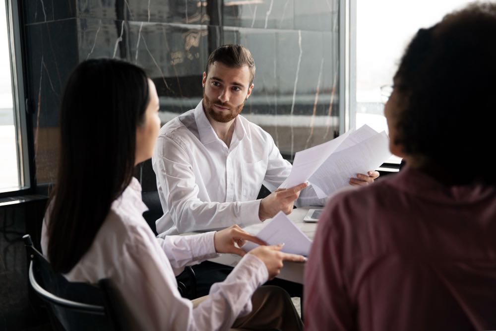 man-showing-his-workmates-documents